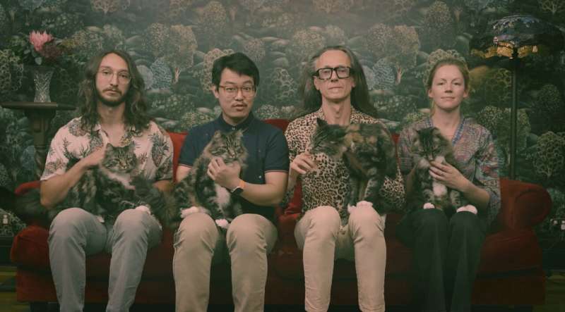 Four UNSW reseachers holding a cat